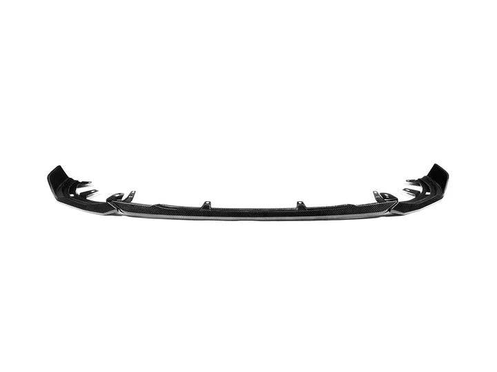 A front view of AUTOTECKNIC DRY CARBON PERFORMANTE FRONT AERO LIP - BMW G42 2-SERIES M-SPORT 2022+ with white background