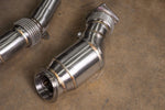 A close-up angled shot focuses on a single Valvetronic Designs 400 Cell Catted Downpipe component from the BMW F8X (M2C/M3/M4) kit. 