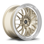 Gold-finished multi-spoke wheel with polished silver outer lip, featuring black center cap with white logo text - APEX Wheels wheel for 17x9 ET42 5x100 - Gloss Motorsport Gold - Machined Lip