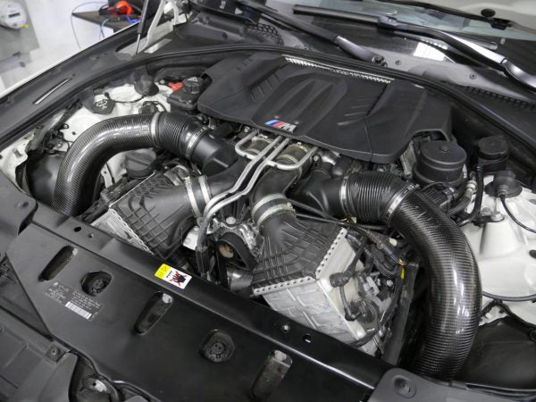 A side top view of RK Autowerks F1X M5 M6 CARBON FIBER INTAKES fitted on a car