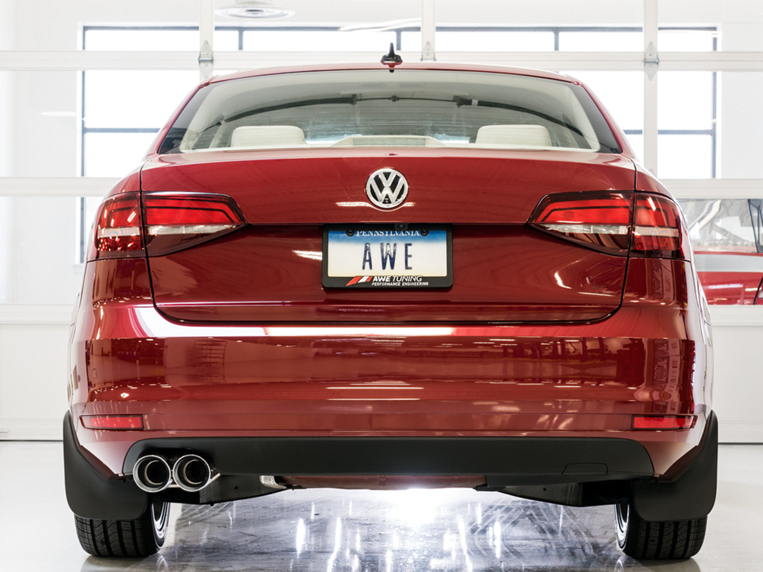 Rear view of a red Mk6 Jetta 1.4T with the AWE Touring Edition and twin Chrome Silver tips