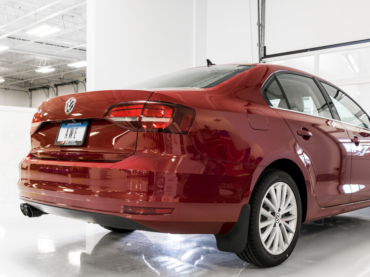 Rear three-quarter view of a red Mk6 Jetta fitted with AWE Touring Diamond Black tips