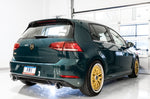 Green GTI Mk7.5 on gold wheels, rear three-quarter studio view showing AWE tips
