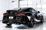 Black GR Supra rear three-quarter view in a studio fitted with AWE Touring Edition tips