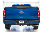 Rear view of a blue F-150 Regular Cab in a studio fitted with the AWE 0FG exhaust