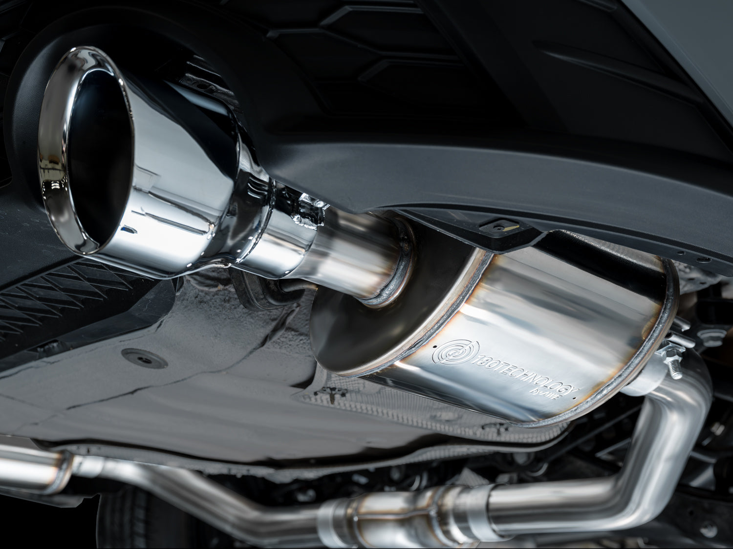 Close-up of a 5-inch Chrome Silver AWE slash-cut tip under the GLI rear bumper