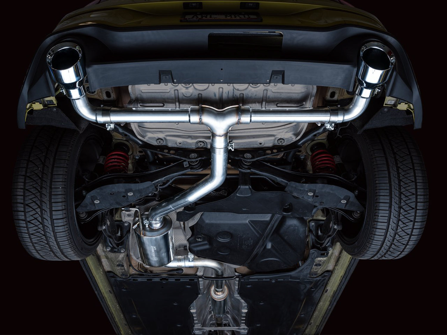 Underside of a yellow Mk8 GTI with the AWE Touring Edition cat-back fitted