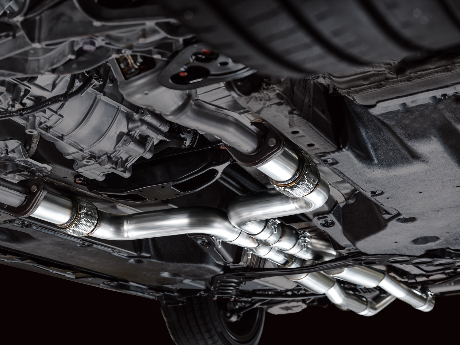Angled underbody shot of the full AWE Touring system running the length of a Nissan Z