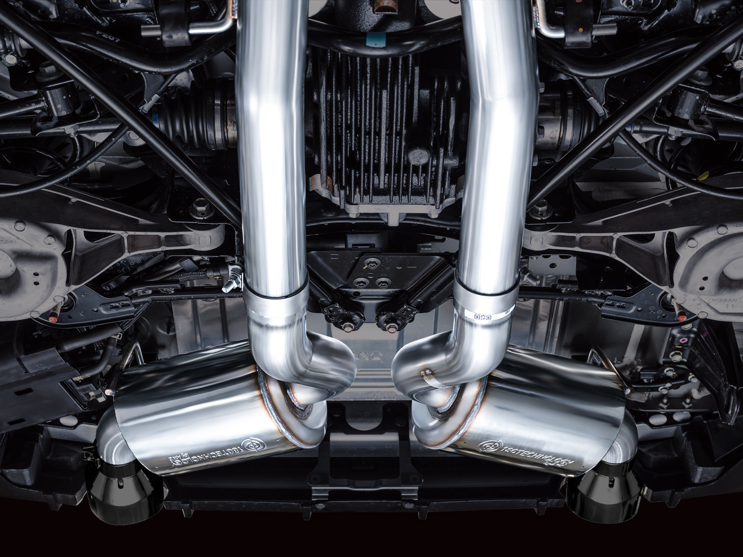 Straight-up underbody view of the AWE dual 3-inch pipes and X-pipe on a Nissan Z
