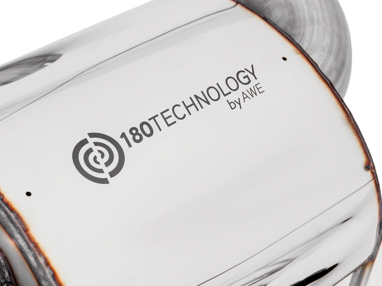 Close-up of the 180 Technology by AWE logo etched on a polished Touring muffler case