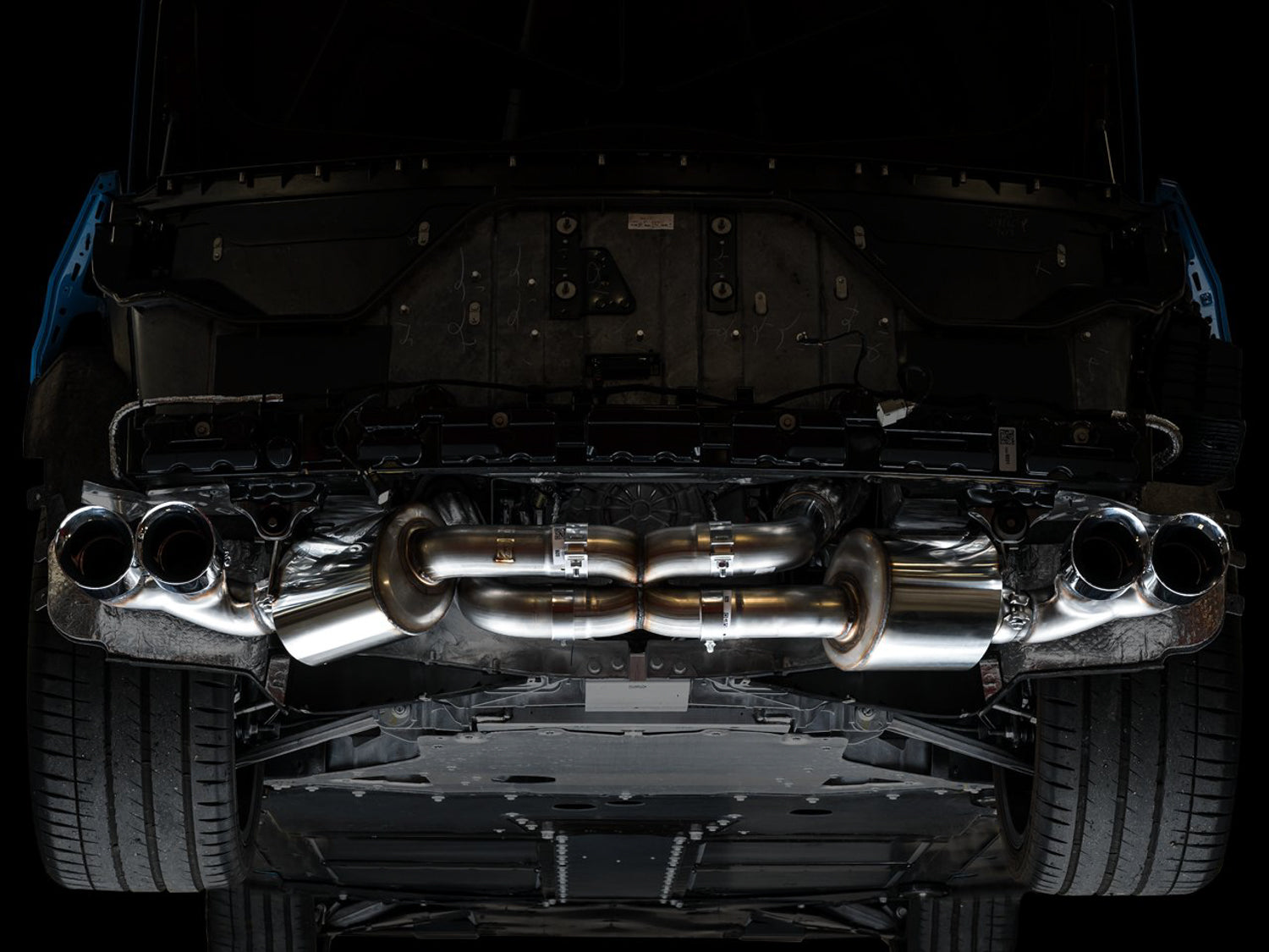Underside of a C8 Corvette showing the AWE Touring Edition exhaust fitted with chrome tips