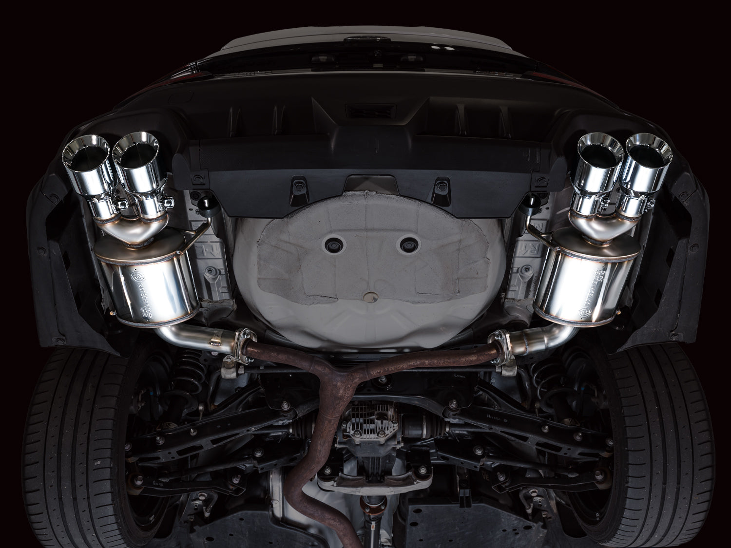 Underside view of the AWE Touring axle-back installed on a VB WRX behind the factory mid-pipe