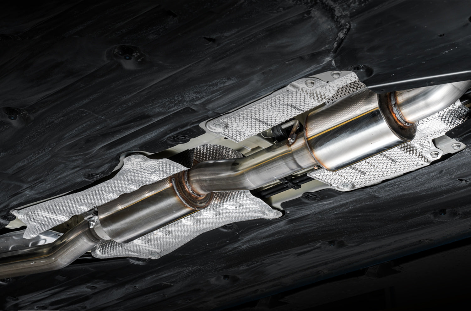 Underbody view of the AWE stainless mid pipe section fitted under an FK8 Civic Type R