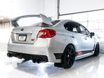 White VA STI rear three-quarter in a studio fitted with AWE Diamond Black Touring tips