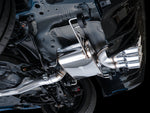 Close side view of the AWE Touring muffler and chrome triple tips under an FL5
