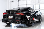 Black GR Supra rear three-quarter in a studio showing AWE Non-Resonated Touring tips