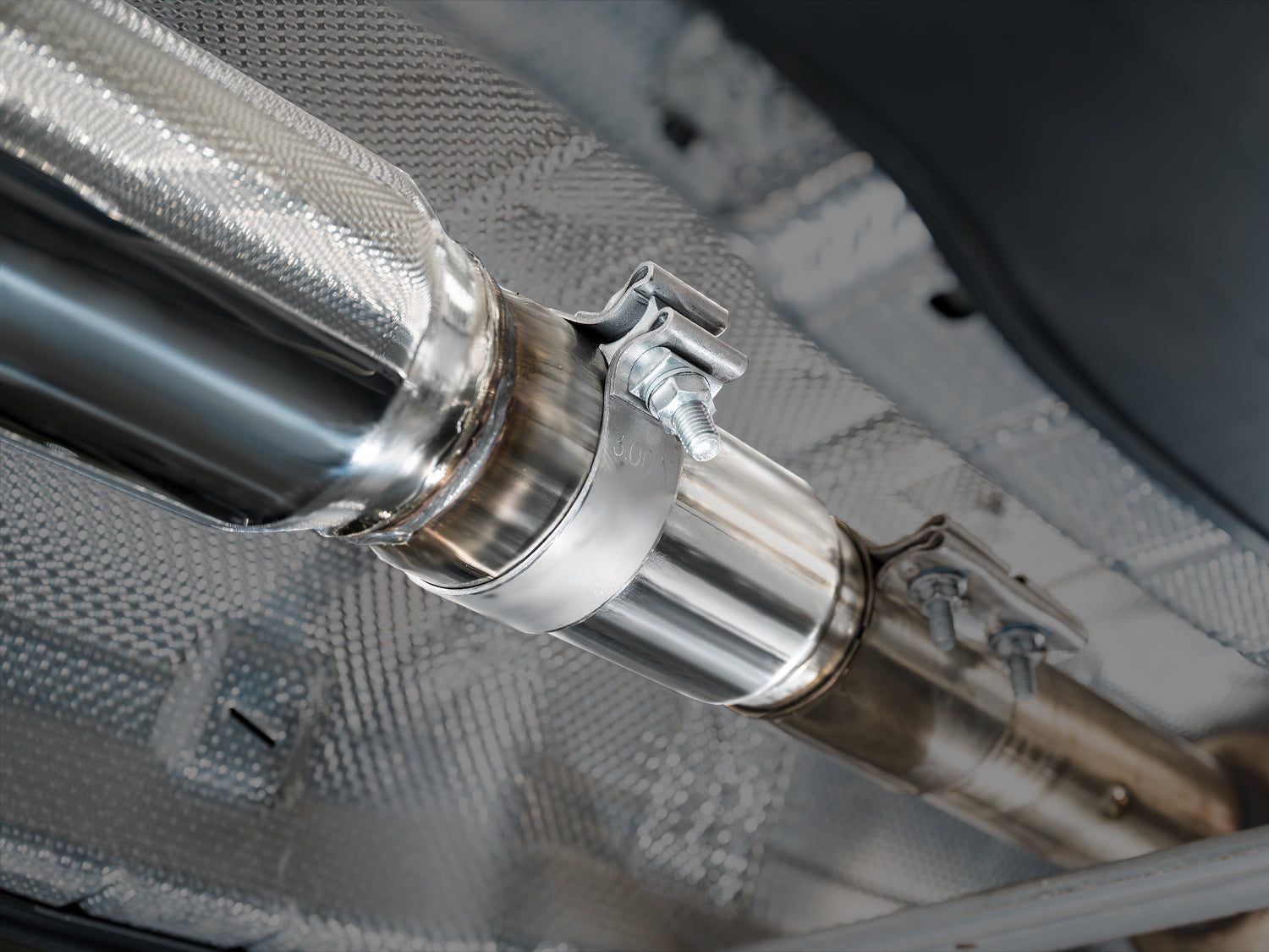 Close-up of an AWE band clamp joint on the Track Edition under the GLI