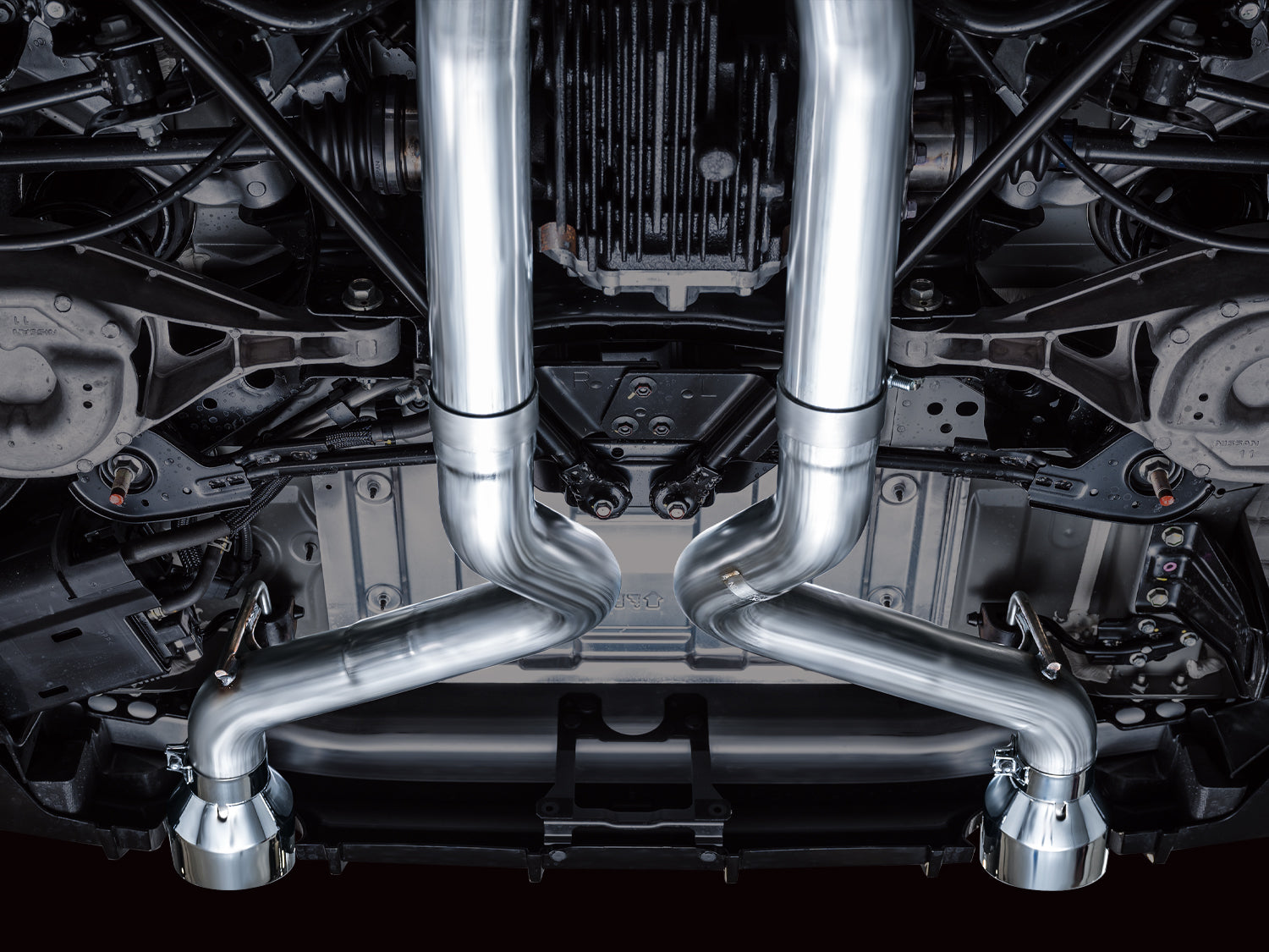 Underbody view down the center of a Nissan Z showing the AWE Track X-pipe junction