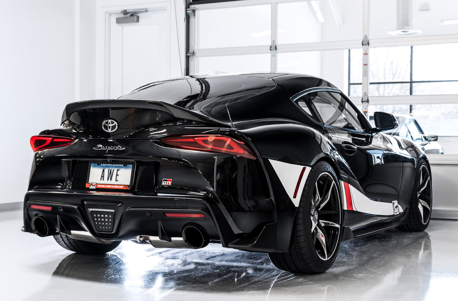 Black GR Supra rear corner in a studio fitted with AWE Diamond Black Touring tips