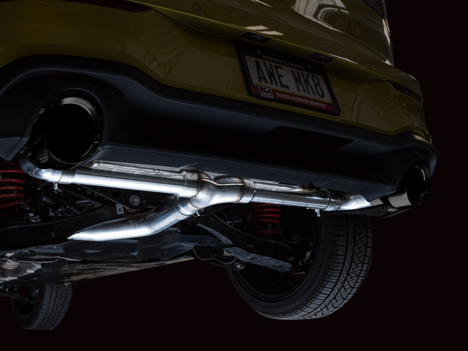 Close-up of a 5-inch Diamond Black AWE tip under the Mk8 GTI rear bumper