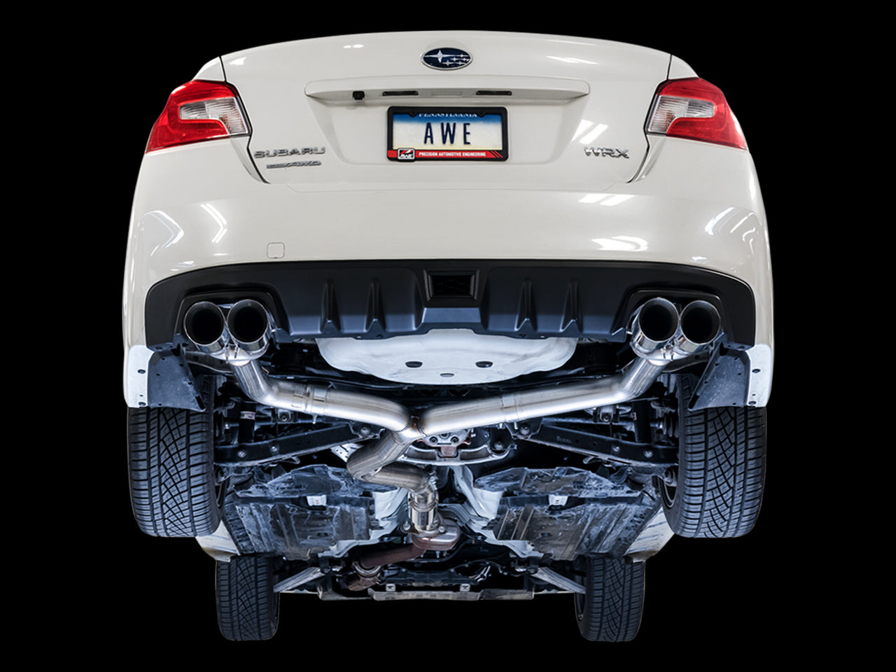Underside of a WRX on a black backdrop showing the AWE Track Edition straight rear sections