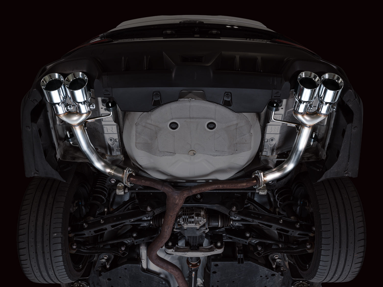 Underside of a white VB WRX with the AWE Track Edition axle-back pipes installed