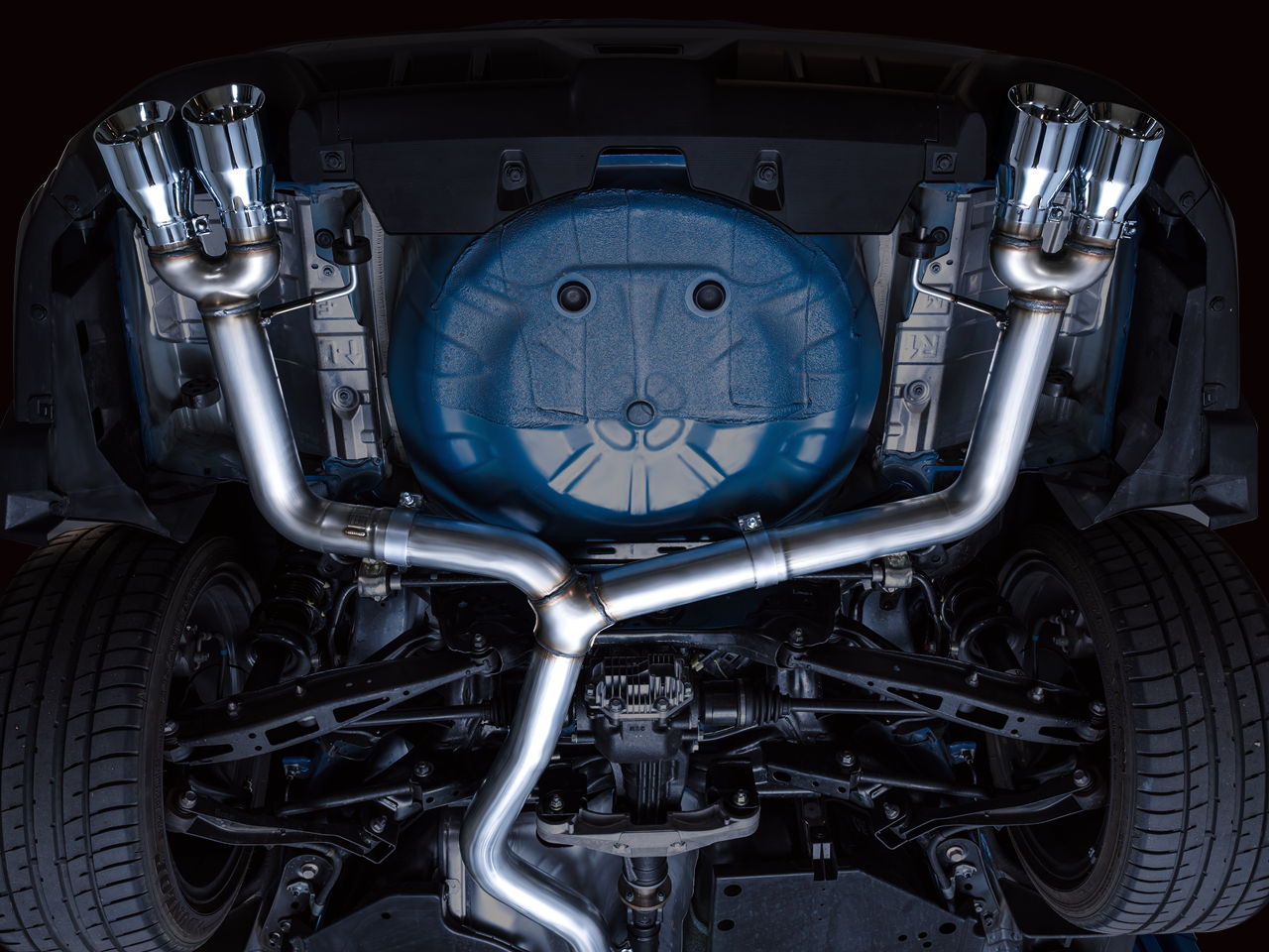 Underside of a blue VB WRX with the AWE Track Edition cat-back installed, no rear mufflers