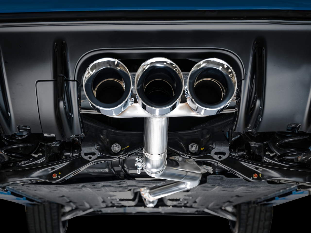 Close view of AWE chrome triple tips and trident merge fitted under an FL5 diffuser
