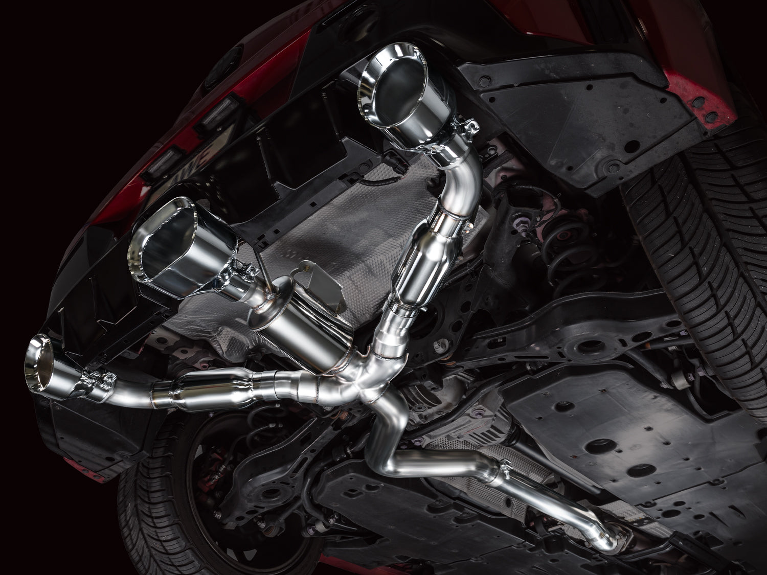 Underside of a GR Corolla fitted with the AWE Track Edition exhaust and chrome tips