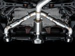 Underbody view from behind of the AWE Track tri-merge splitting into three outlets