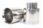 A close-up view of the two polished stainless steel exhaust tips. The image highlights the double-walled, slant-cut design with a mirror finish and the laser-etched Dinan logo on the top of each tip.