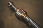 A close-up view of a stainless steel exhaust resonator showing high-quality welds and integrated oxygen sensor bungs.