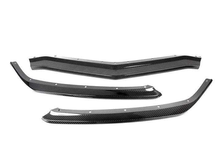 A top view of some of the parts of AUTOTECKNIC DRY CARBON COMPETITION FRONT AERO LIP - CHEVROLET CORVETTE C8 2020-2023 with white background