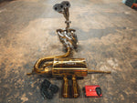 A duplicate full-view shot of the gold-finished Valvetronic exhaust system, showing the complete assembly from headers to dual exhaust tips.