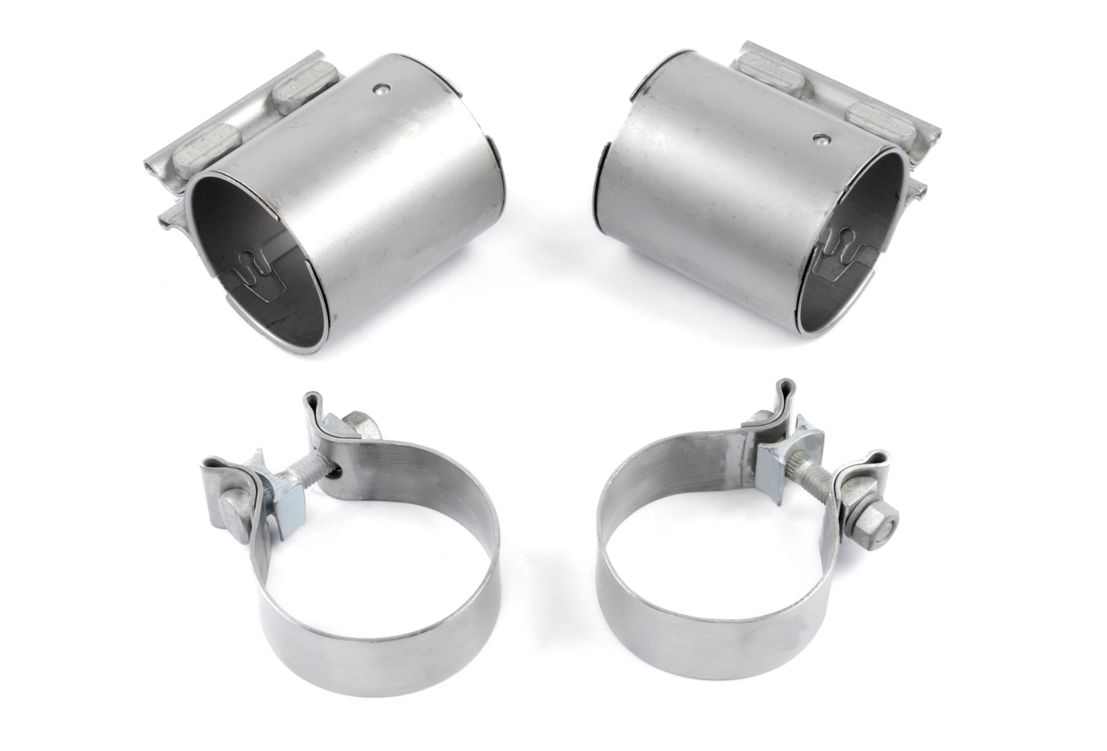 An overhead view of four silver metal exhaust clamps, including two wide cylindrical sleeve clamps with integrated hardware and two circular band clamps with tightening bolts.