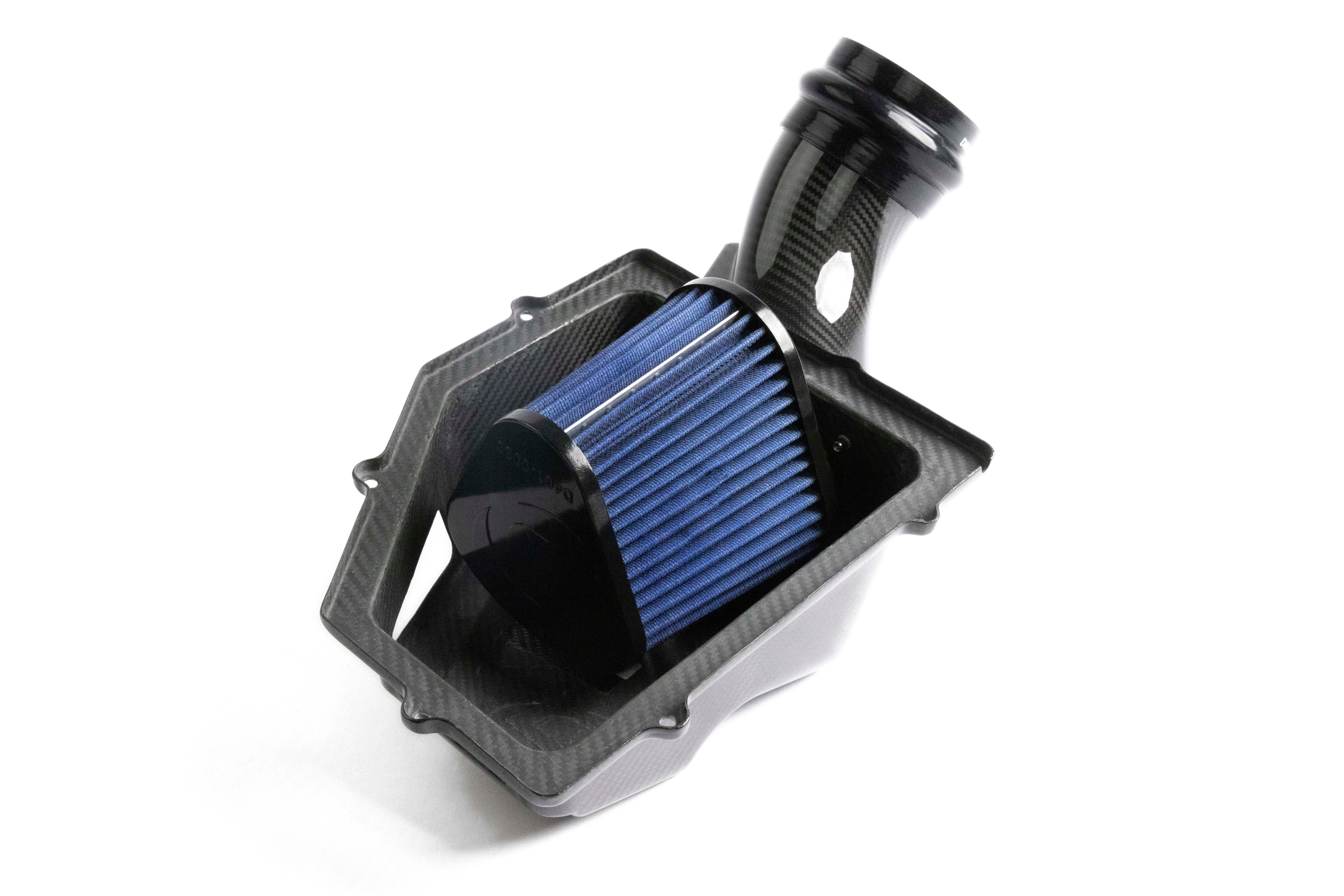 Underside view of the Dinan intake system showing the large, blue high-performance air filter installed within the custom carbon fiber housing to maximize airflow.