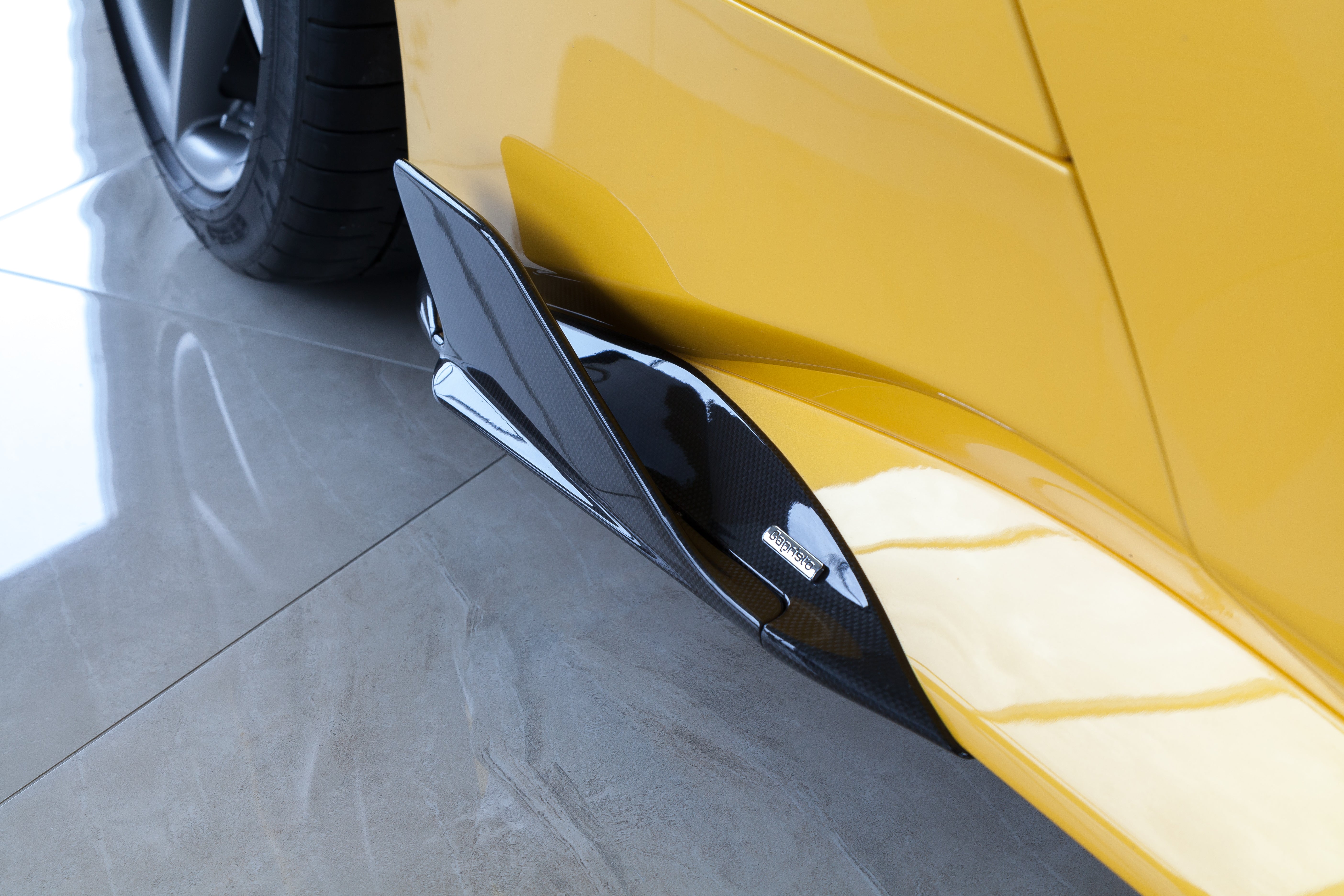 Capristo carbon fiber side fin on a yellow Ferrari 488, low angle