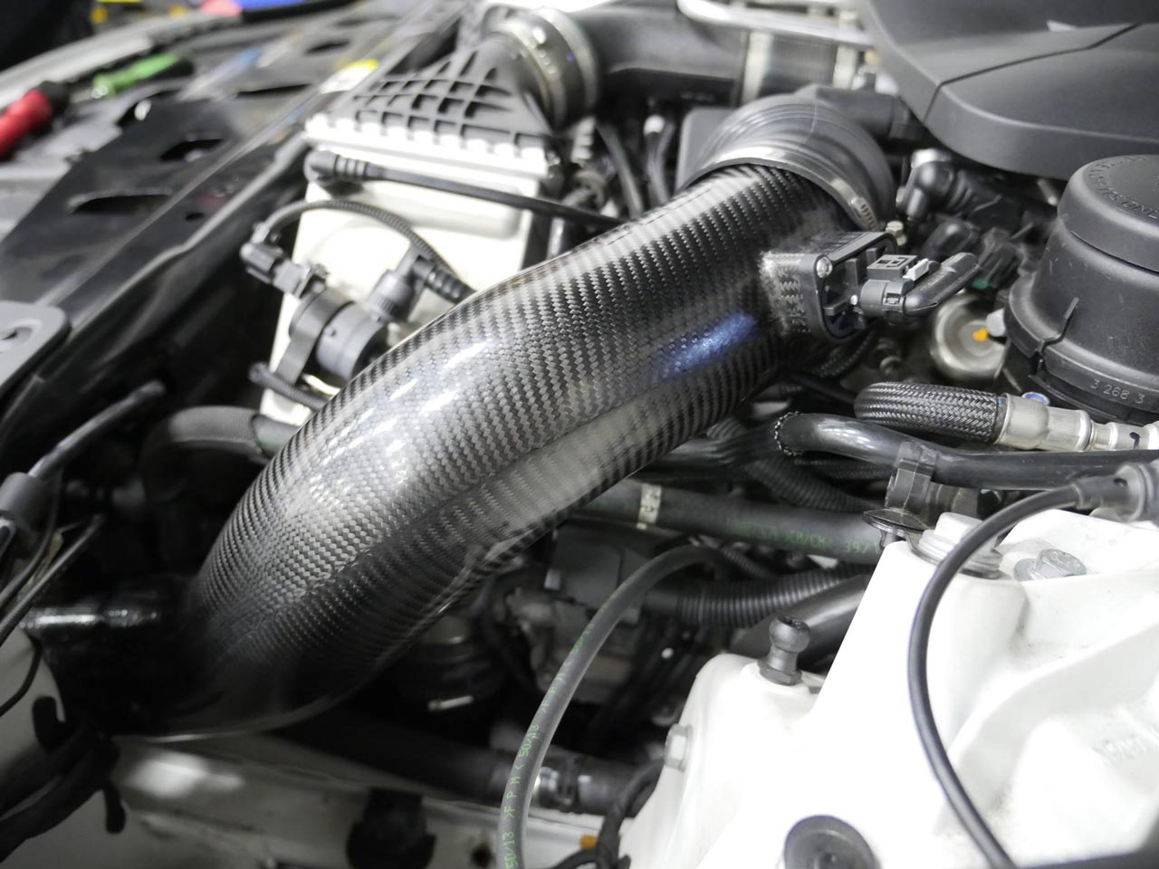 A close up view from the side of RK Autowerks F1X M5 M6 CARBON FIBER INTAKES fitted on a car