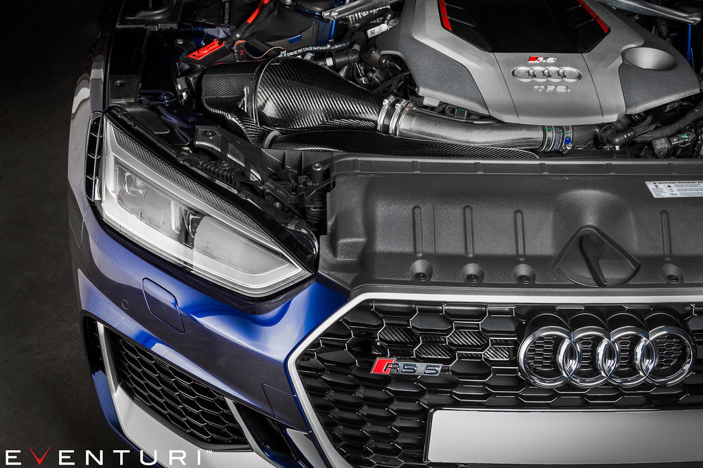 Carbon fiber intake system installed in blue Audi RS5 engine bay with curved intake tubes and airbox - Eventuri intake for Audi B9 RS5
