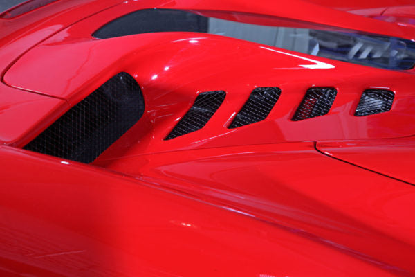 close view of Capistro Primed Top / Clear Gloss Bottom Carbon and Glass Bonnet Raw for Ferrari 458 Spider 2011-2015 fitted inside a red car