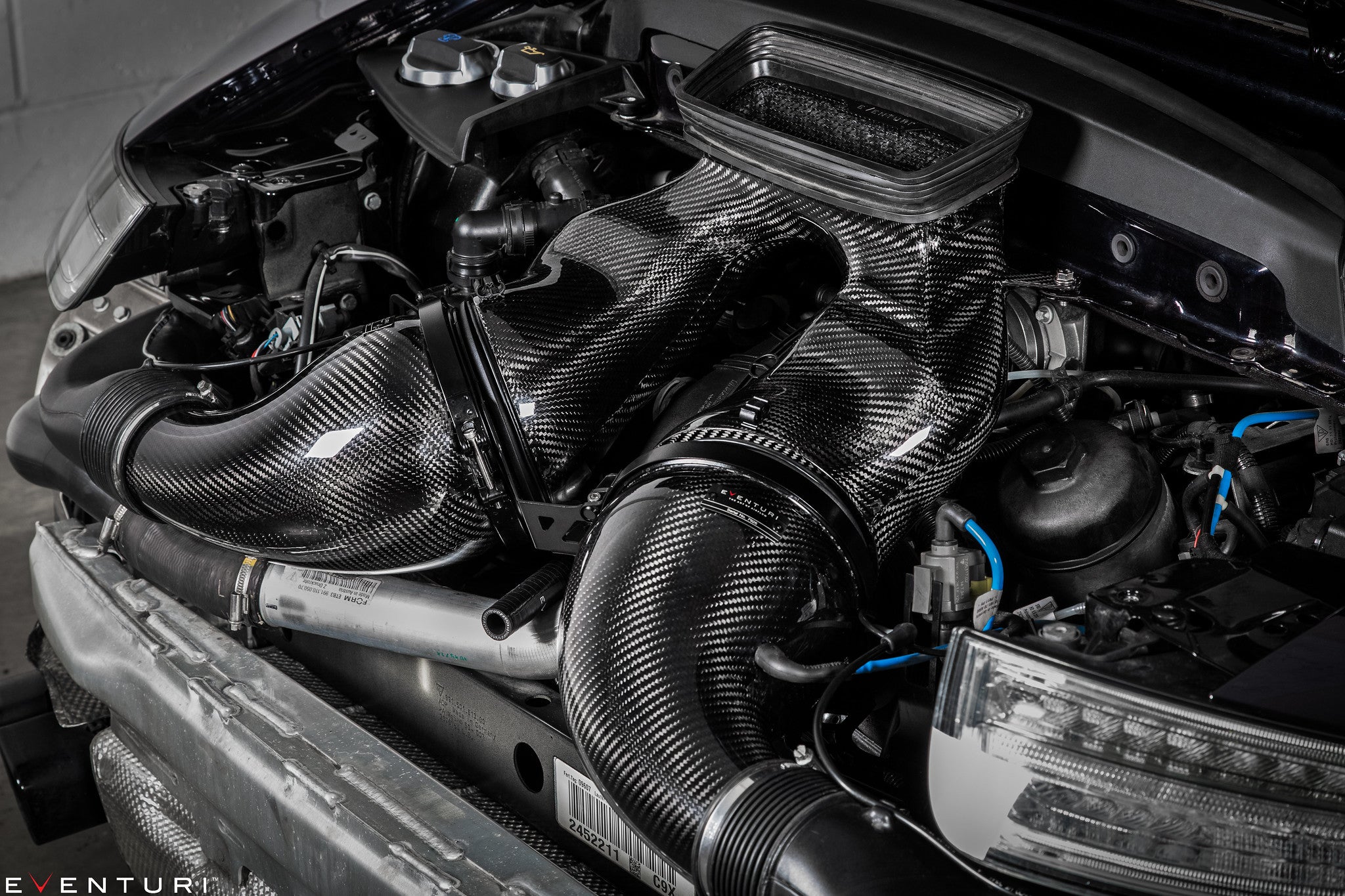 Carbon fiber intake system with curved tubes and airbox installed in engine bay - Eventuri intake for Porsche 911
