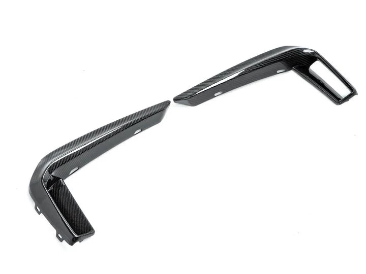 A side wide view of AUTOTECKNIC DRY CARBON FRONT BUMPER TRIM - BMW G30 5-SERIES M-SPORT 2017+ with white background