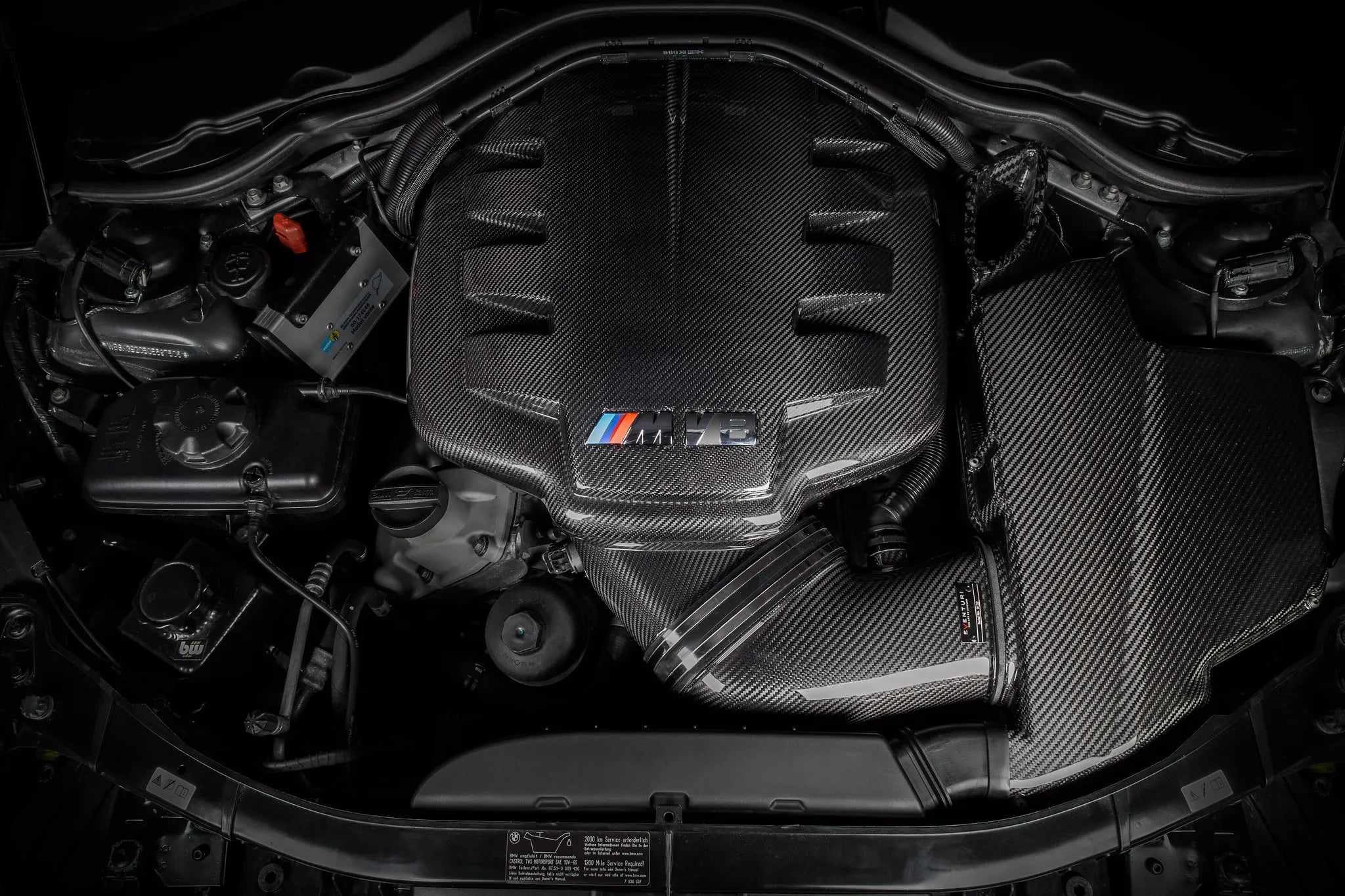 Top view of the Eventuri gloss plenum fitted to the S65 V8, M V8 emblem centered