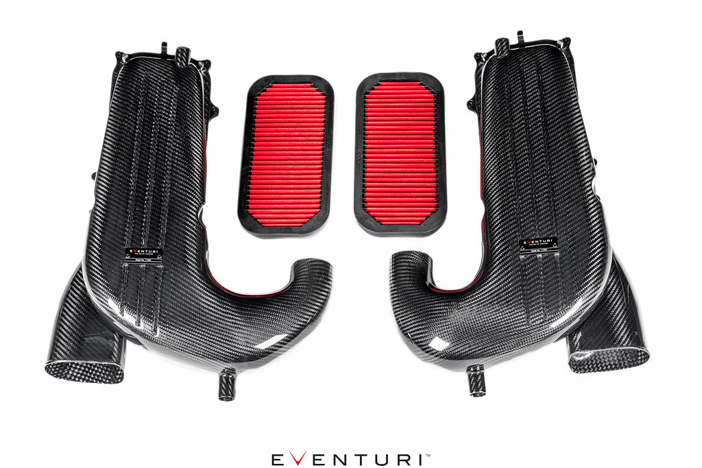 Two carbon fiber intake tubes with red pleated air filters displayed on white background with logo watermark - Eventuri intake for Mercedes-Benz C63