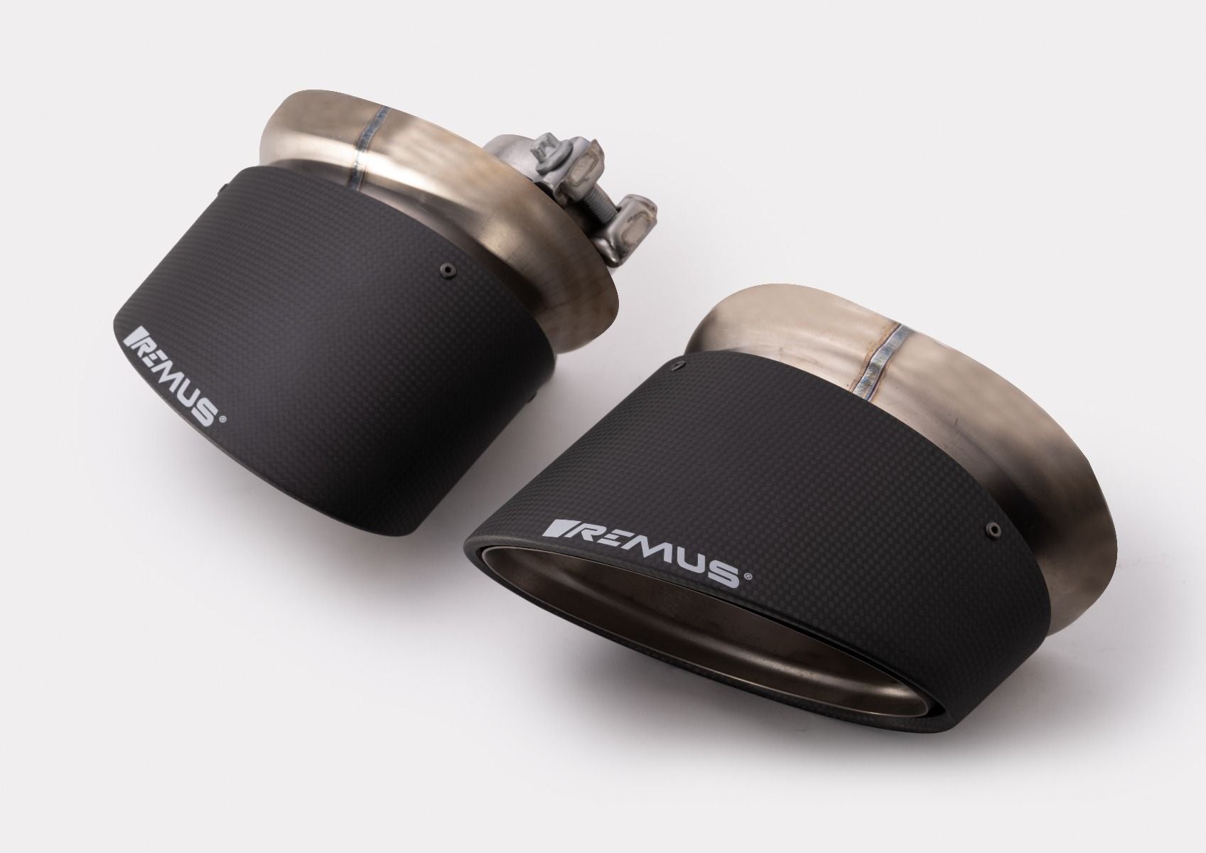Pair of oval black carbon tail pipes, 108mm Carbon tip option for the Remus 8V S3 Axle-Back Exhaust Sedan