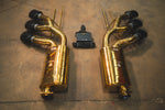 Rear view of the exhaust system components showing the inlet flanges of the gold mufflers and the triple exhaust tip configuration.