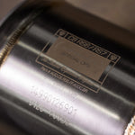 Close-up of Valvetronic Designs Special Ops identification plate on Audi C8 RS6/RS7 catted downpipe, showing part number AUD.C8.RS6.FF.400C.BR and precision TIG welding.
