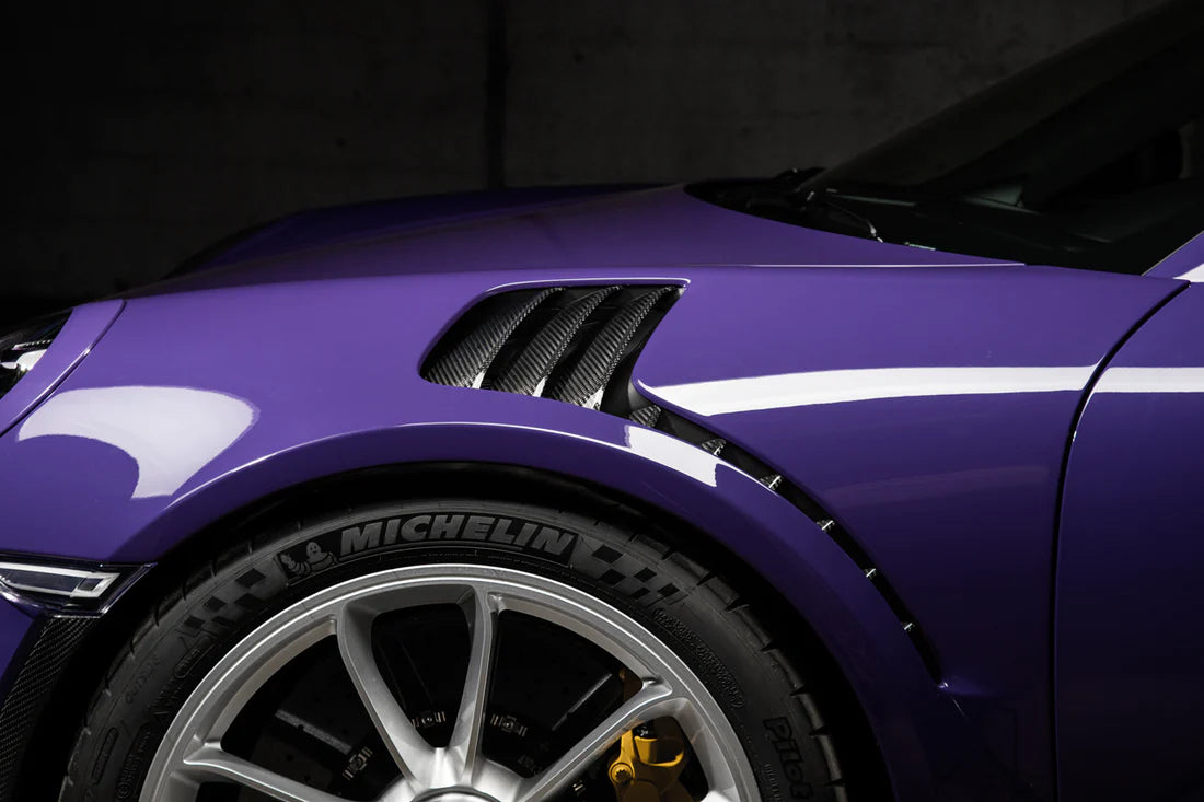 A side view of TECHART Air Outlet panels in Carbon "glossy" for Porsche 991.1 GT3 RS fitted on a purple Porsche