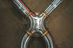 A detailed close-up of a precision-welded X-pipe intersection with labeled "A" and "B" sections on the stainless steel piping.