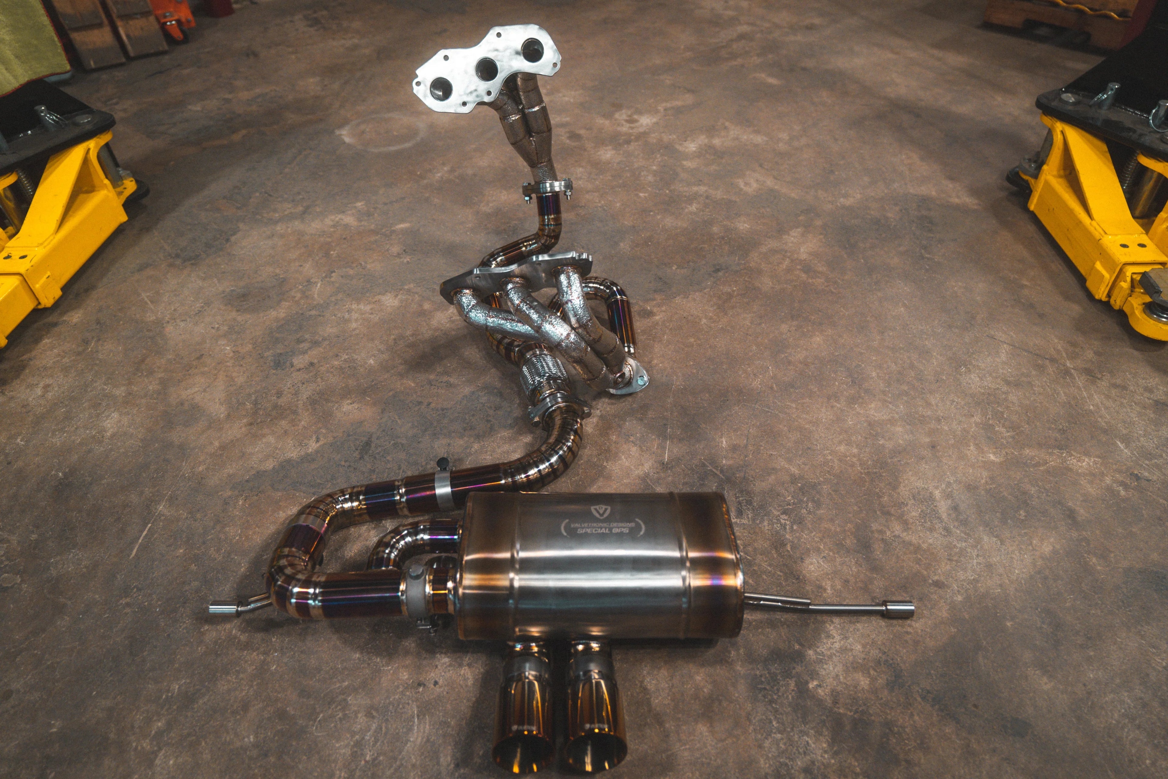 Full view of the titanium-finished version of the exhaust system, featuring heat-blued welds on the piping and muffler assembly.